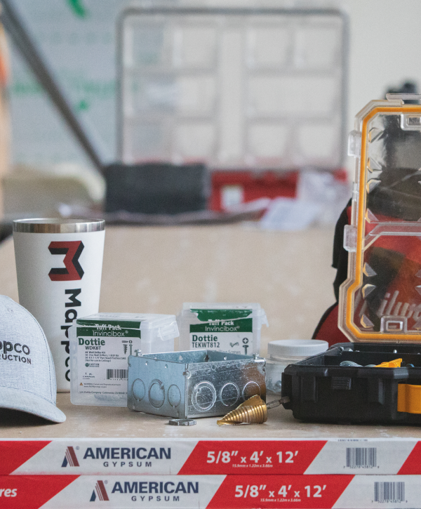 Construction workers standing over architectural plans