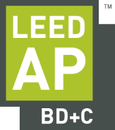 Construction workers standing over architectural plans