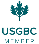 Construction workers standing over architectural plans